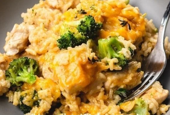 Delicious Cheesy Chicken and Rice Casserole topped with cheese and herbs.