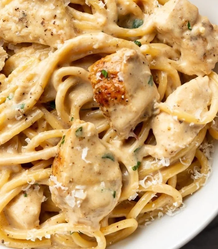 Creamy garlic chicken pasta dish with herbs and cheese