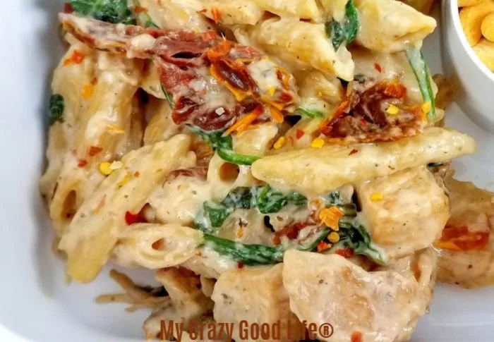 Creamy Tuscan chicken pasta with sun-dried tomatoes and herbs
