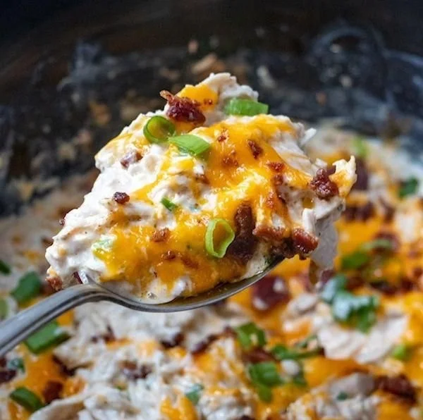 Delicious Crock Pot Crack Chicken served with cheese and green onions