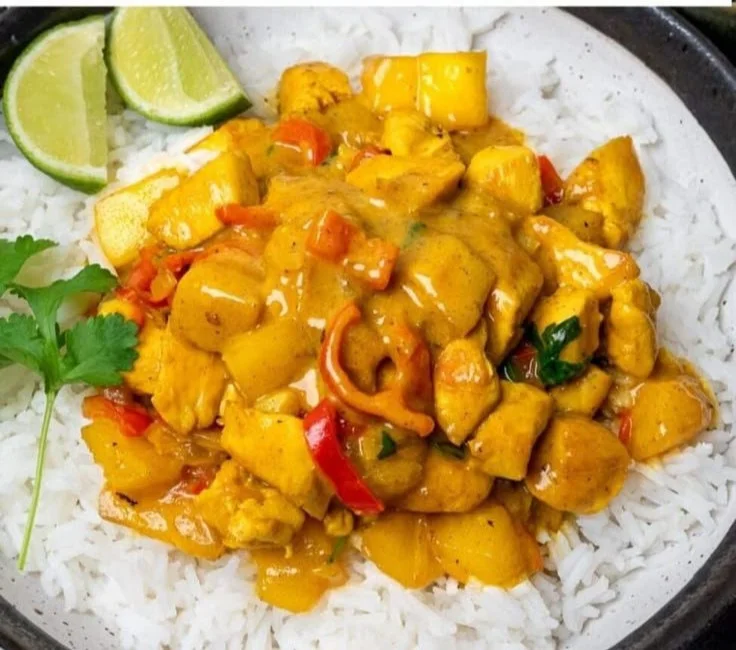 Bowl of easy mango chicken curry with vibrant colors and fresh ingredients