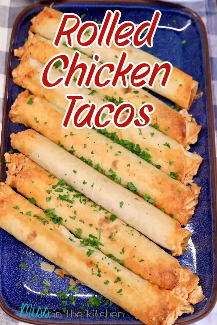 Plate of rolled chicken tacos garnished with fresh toppings