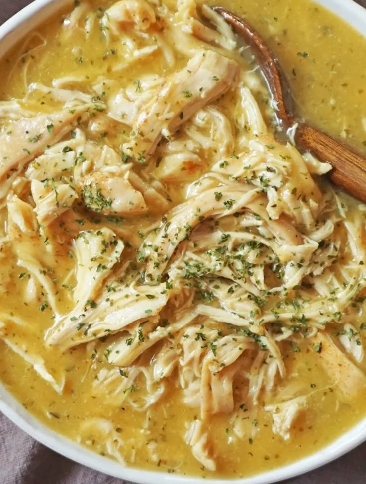 Delicious shredded chicken with creamy mashed potatoes served on a plate.