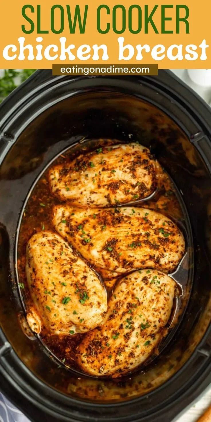 Slow cooker chicken breasts served with vegetables and herbs on a plate