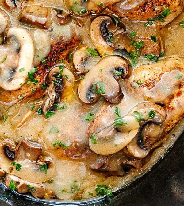 Delicious slow cooker Chicken Marsala with mushrooms and herbs on a plate
