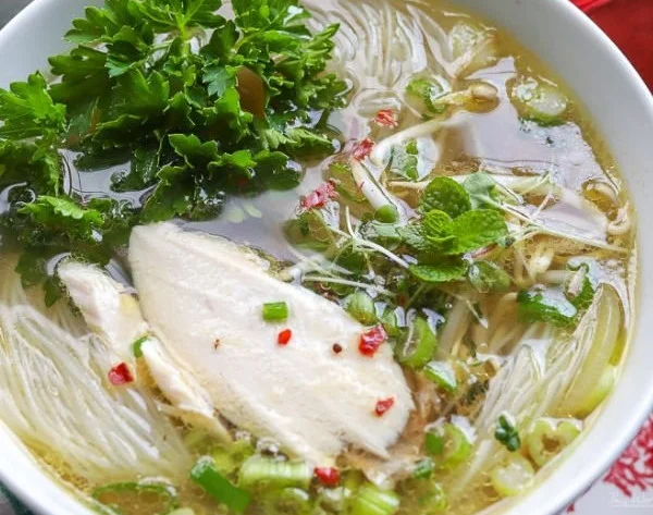 Bowl of spicy chicken pho made with rotisserie chicken and fresh herbs