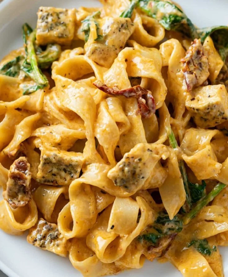Creamy Tuscan chicken pasta with chicken, spinach, and sun-dried tomatoes