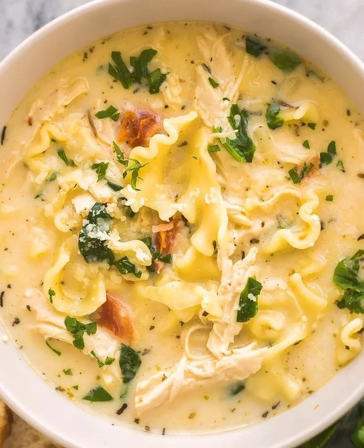 Bowl of creamy white lasagna soup garnished with herbs