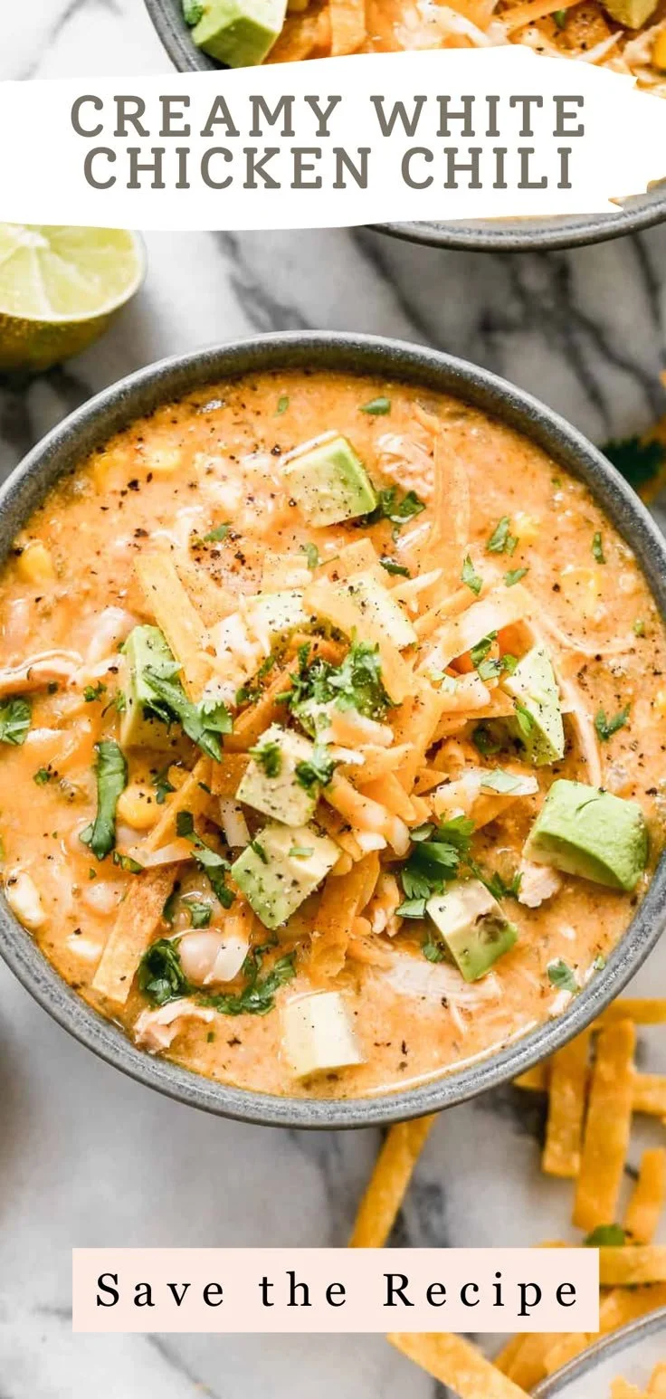 A delicious bowl of creamy white chicken chili topped with cheese and cilantro.