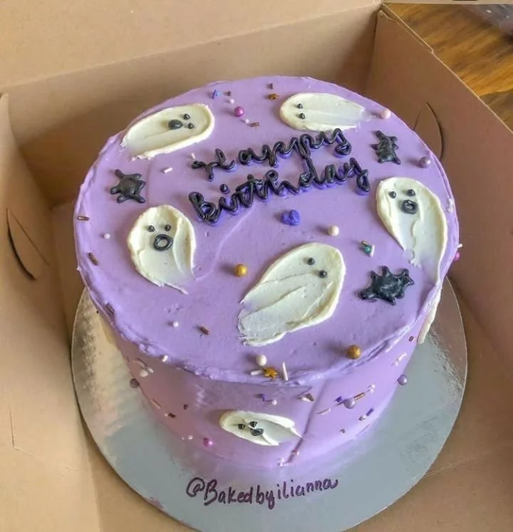 Cute Halloween cake for birthday celebration with spooky decorations and purple icing