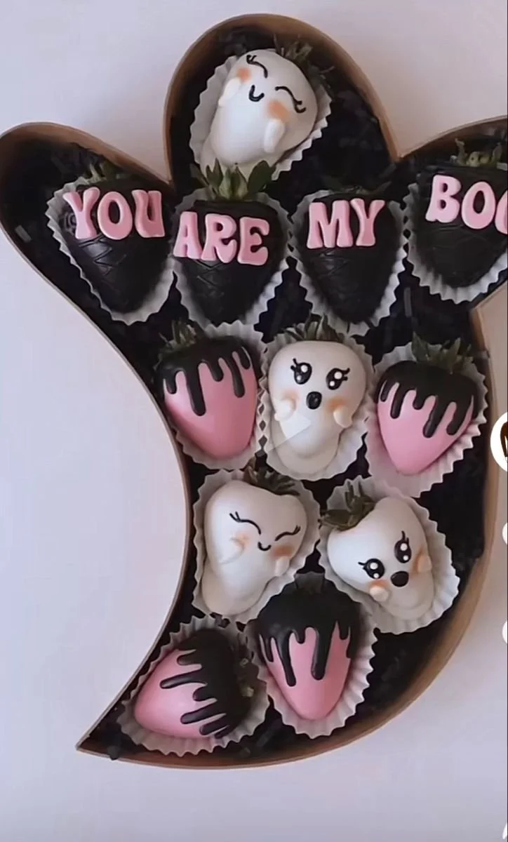 Assorted Halloween chocolate treats including chocolate-covered strawberries.