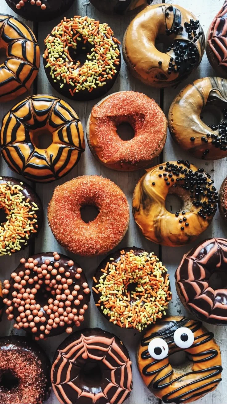 Assorted Halloween donuts decorated with spooky designs and colors