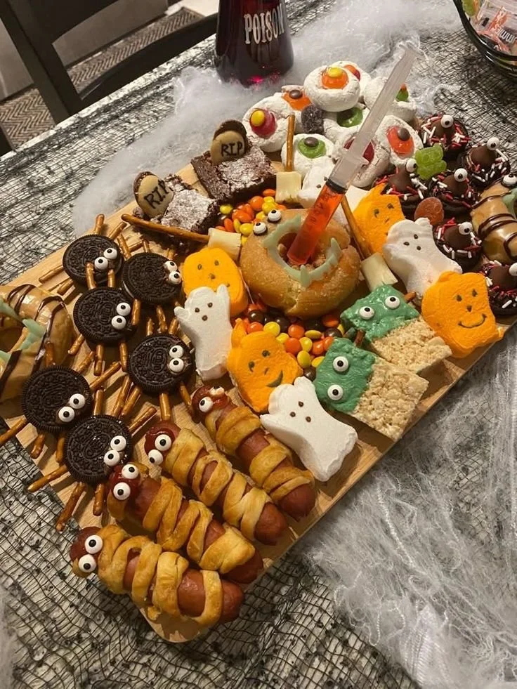 Colorful Halloween snack boards for kids with spooky treats and desserts.