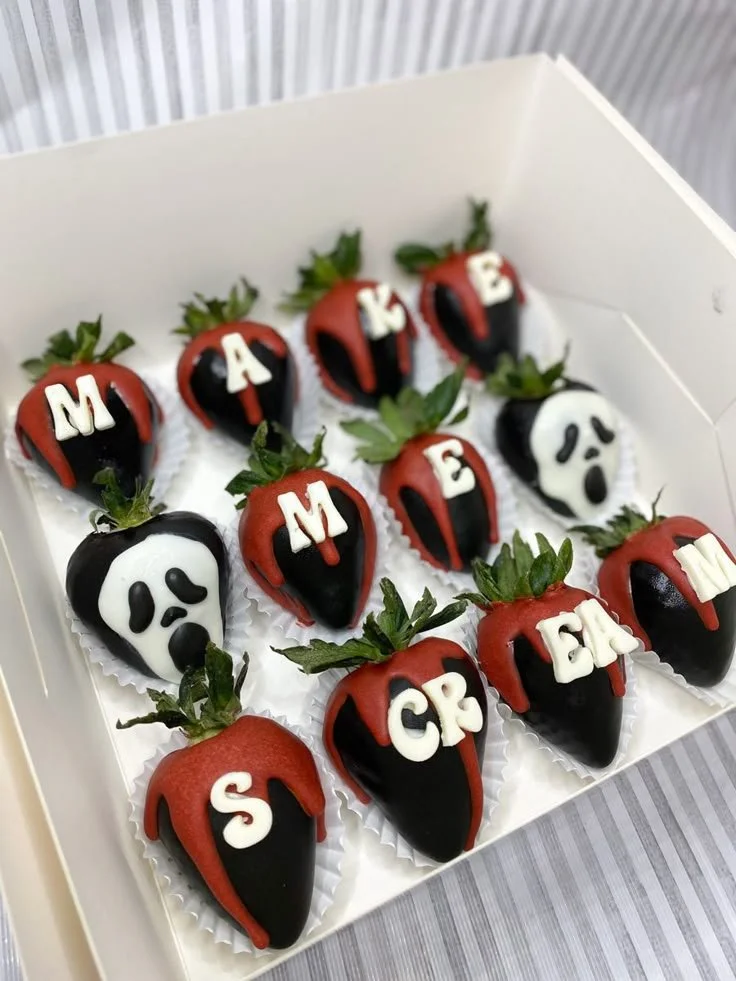 Decorative Halloween strawberries dipped in chocolate and themed decorations