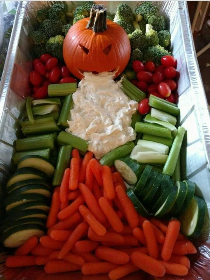 Halloween skeleton veggie tray with colorful vegetables and dip