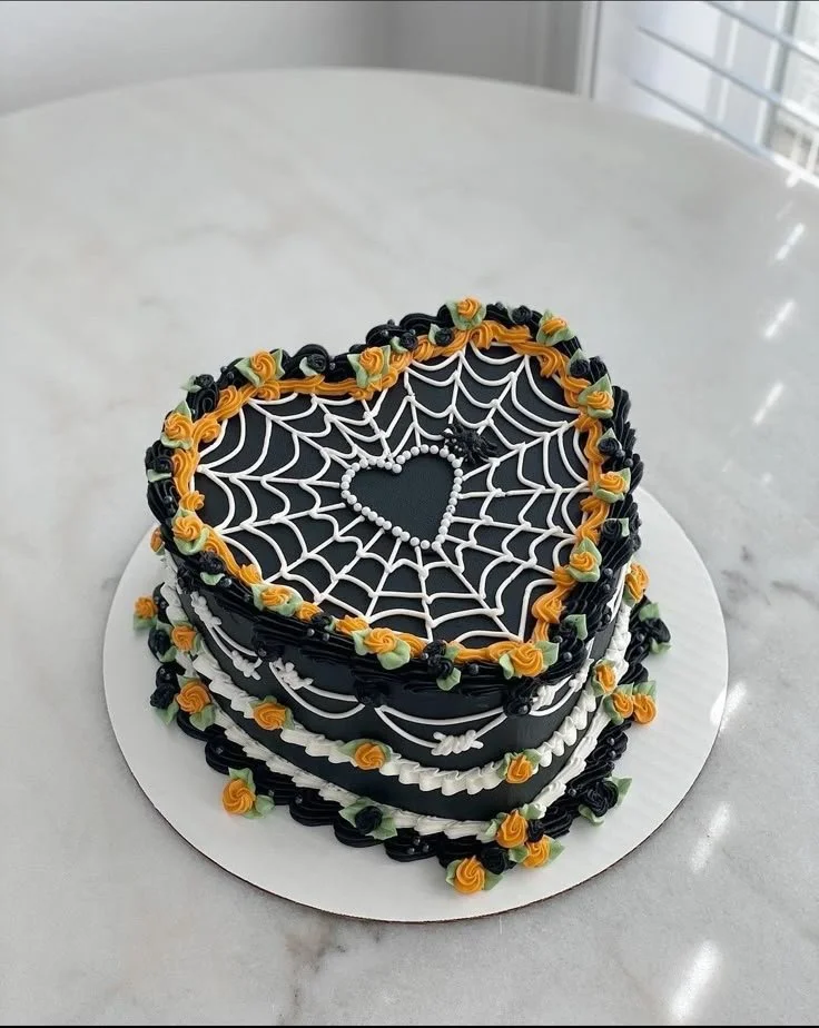 Pretty Halloween cake with spider webs and vibrant orange flowers decorations