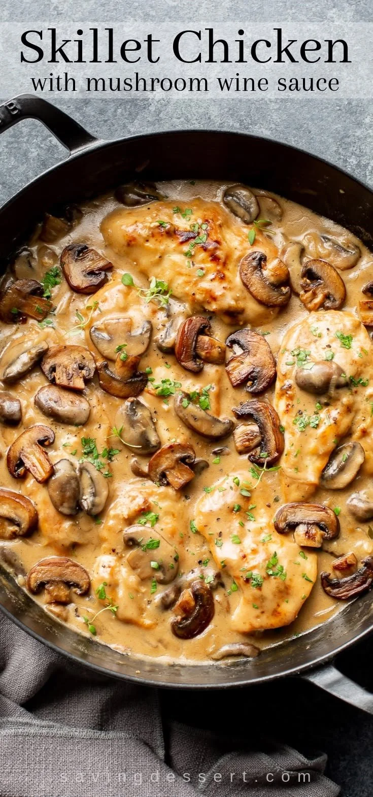 Skillet chicken topped with mushroom wine sauce garnished with herbs