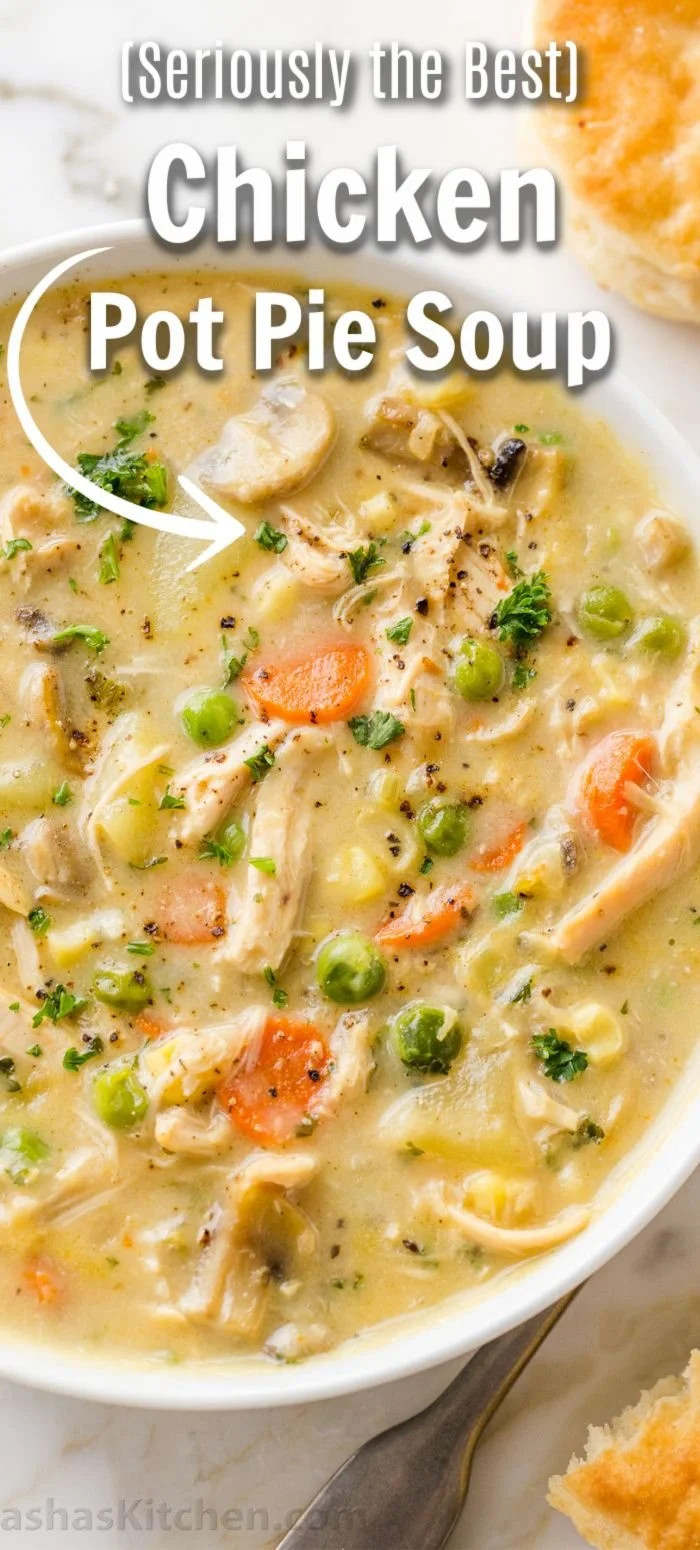 Bowl of Chicken Pot Pie Soup with vegetables and herbs garnished on top